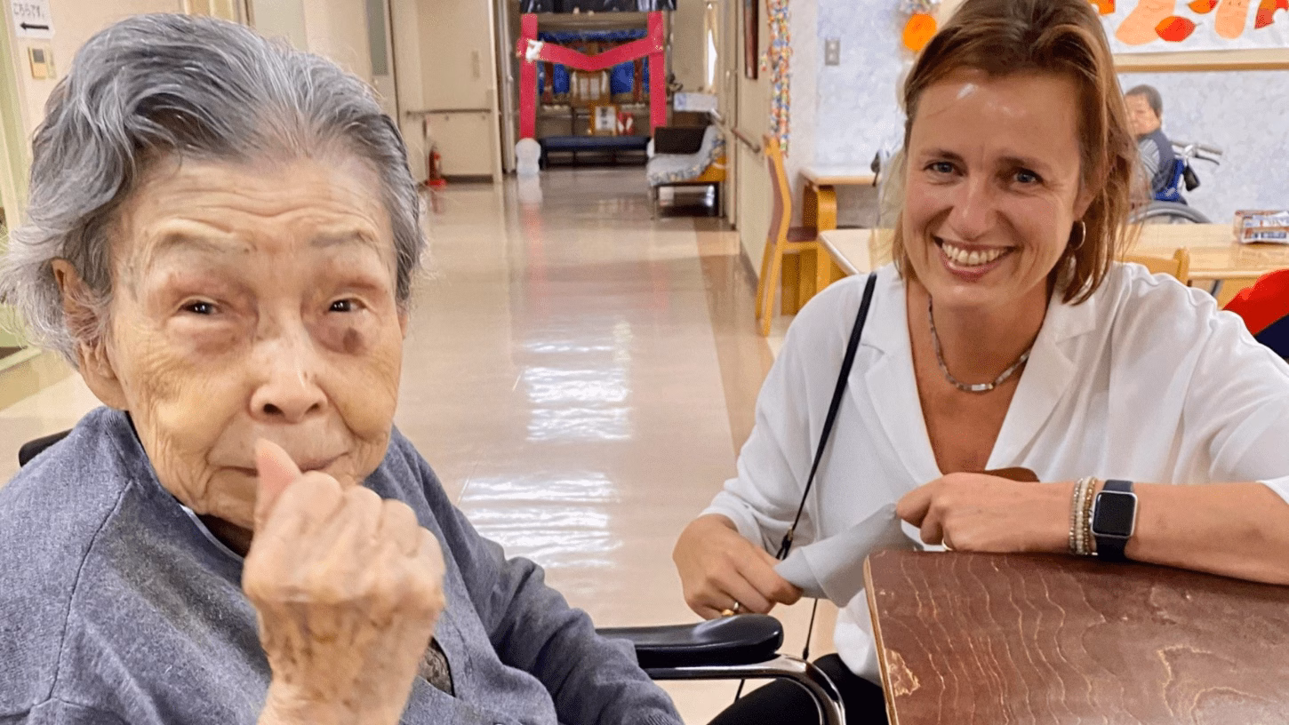 PhD student Monique Daniels poses with a 100 year old Japanese woman whilst doing her research on end-of-life care.
