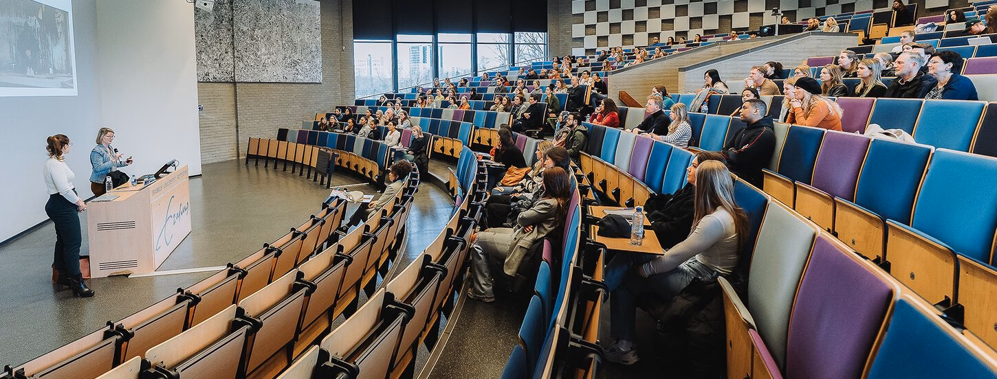 students sitting in a large classroom 