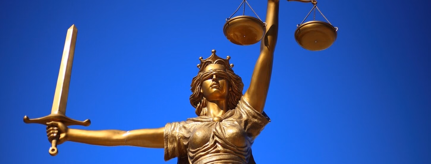 A statue of lady liberty against a blue sky