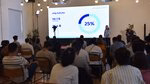 An audience of potential investors attends a presentation about Art Inception
