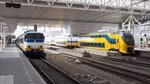 Two NS trains at a Dutch train station.