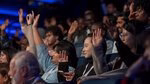 Members of the audience raising their hands 