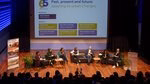 An overview photo of the speakers and moderator of the second panel