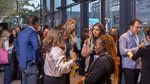 Attendees networking with speaker