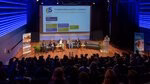 An overview photo of the panelists, moderator and audience, as seen from the backrow