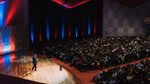 Lecturer explains an bachelor's programme on stage to prospective students.