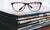 A piece of newspapers with a pair of glasses on top.