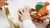 Children hand playing with wooden colourful dinosaurs