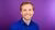Portrait photo of Nèwel Salet with a neon purple background.