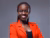 Portrait photo of researcher Vivienne Sserumaga Mulema wearing a bright red blazer with a gray background.