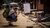 Backpacker photographing a child sitting