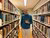 Student Saeed Kallas posing in between rows of books in the library.