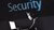 Man die naar een beeldscherm kijkt met boven hem de tekst Security