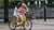 Father teaches child how to ride a bike.