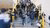 Middle school students walk up the stairs in the hall of their school.