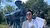 Kadek looks happy with his diploma, standing in front of the Erasmus statue on campus