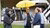 Alumni standing under an Erasmus Economics umbrella