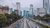 Busy street in Jakarta with skyscrapers in the distance