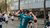Running participant cheers with two thumbs up.
