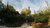 De groene campustuin op campus Woudestein met Tinbergen gebouw in de verte.