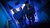Guys walking up the stairs with dim blue and purple light
