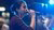 student on stage singing into a microphone