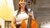 woman standing holding a cello and smiling