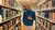 Student Saeed Kallas posing in between rows of books in the library.