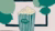 Illustration of green-and-white striped popcorn tub in front of a screen with green speech bubbles
