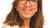 Blurred-faced woman with shoulder-length brown hair in white collared shirt on white background