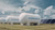 White Hydrogen H2 tanks with wind turbines and solar panels under cloudy sky