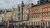 Zagreb city plaza framed by ornate historic stone and red brick buildings under cloudy sky