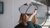 Woman adjusting a VR headset cable in a bright room.