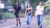 3 students walk on the street.