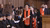 Sigrid Hemels in black gown with red stole and black top hat holding a roled up document in cathedral-like hall