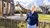 Belinde Bakker standing in front of two giraffes
