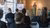 Rianne Kok presenting a diagram to seated audience in modern meeting room