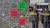 Satellite map with green and red squares beside two Dutch police officers at a bus stop